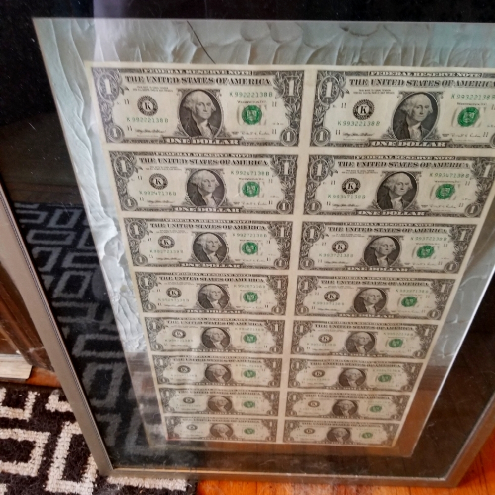 Uncirculated, uncut dollar bills, professionally framed.